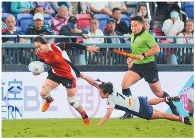  11月12日，山东队球员唐铭琳（左）在比赛中突破防守。当日，在香港举行的第十五届全国运动会七人制橄榄球女子小组循环赛中，山东队31比12战胜香港队。新华社记者 朱 炜摄