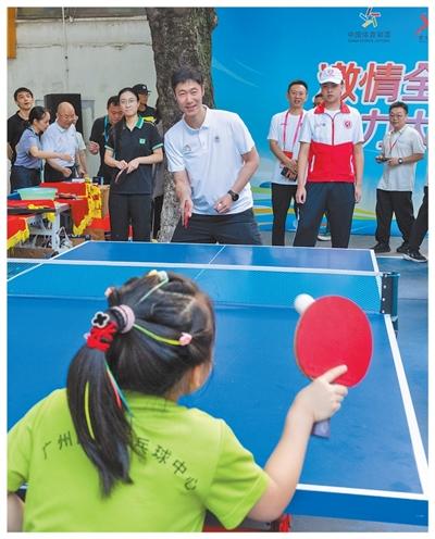 广东广州,中国乒协主席王励勤与乒乓球爱好者切磋交流。姚志豪摄